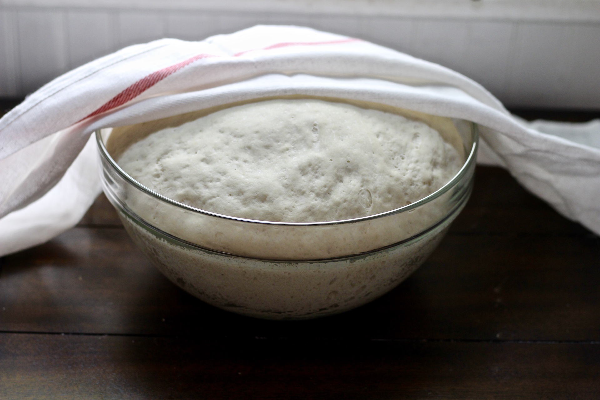 Glass bowl with dough doubled in size.