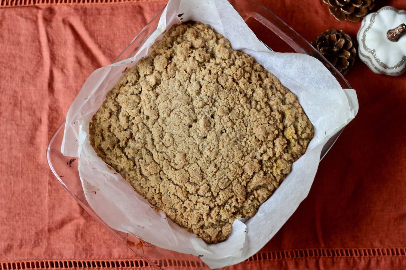 Pumpkin Spice Coffee Cake on an orange table cloth.
