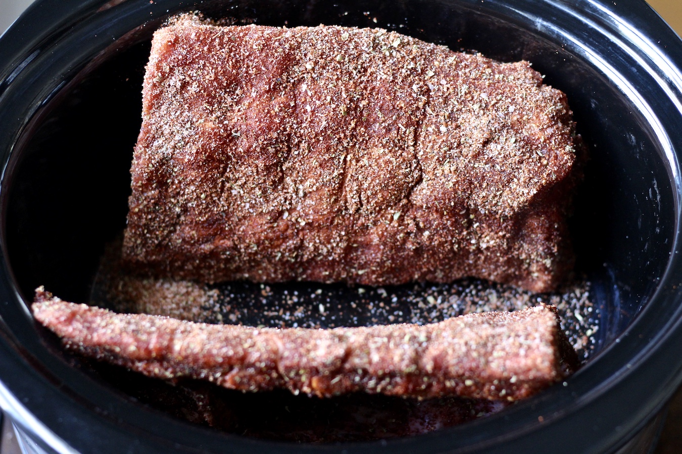 Raw Dry-Rubbed Slow Cooker Ribs in a crock pot