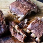 Dry-Rubbed Slow Cooker Ribs on a wooden cutting board