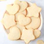 A close up of a white plate with heart, star, and circle shaped dairy-free sugar cookies.