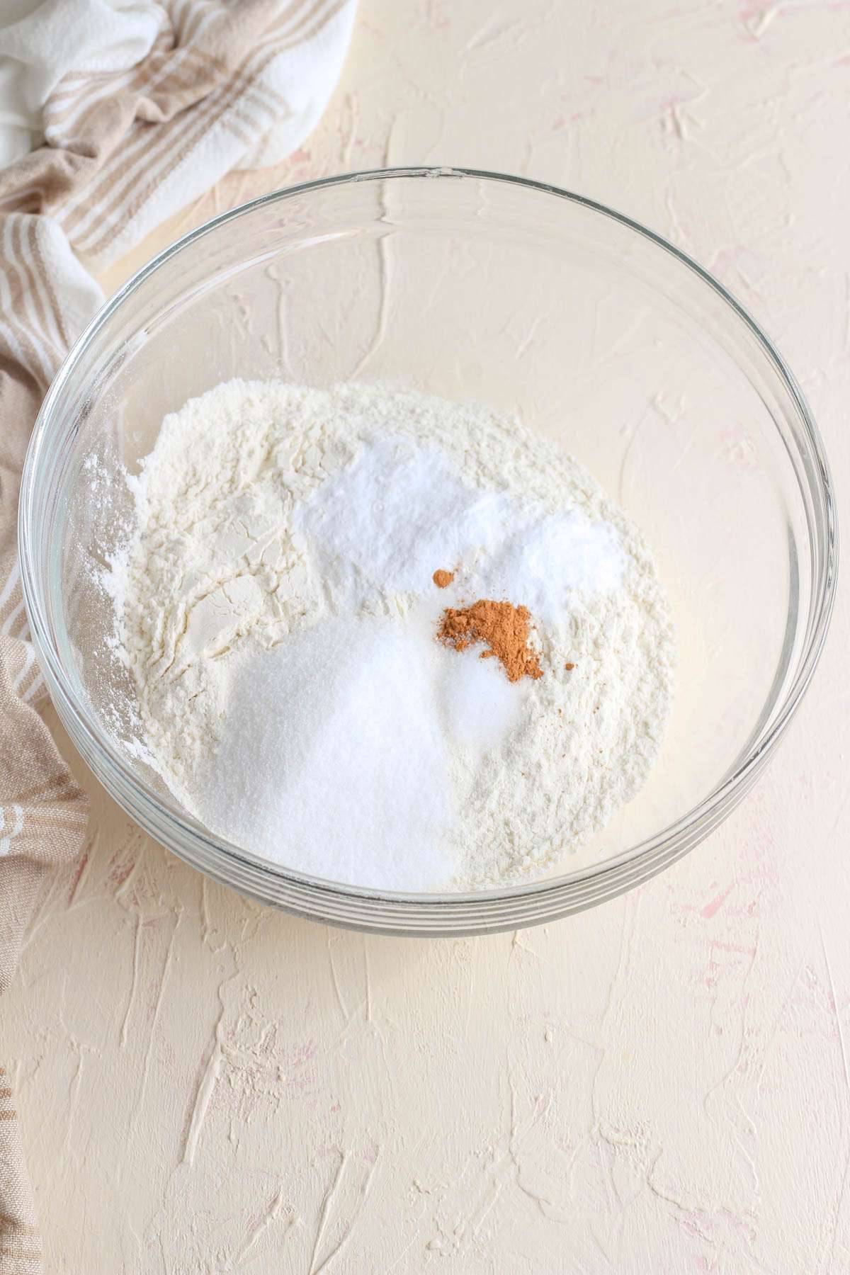 A glass mixing bowl with dry ingredients for dairy free buttermilk pancakes.