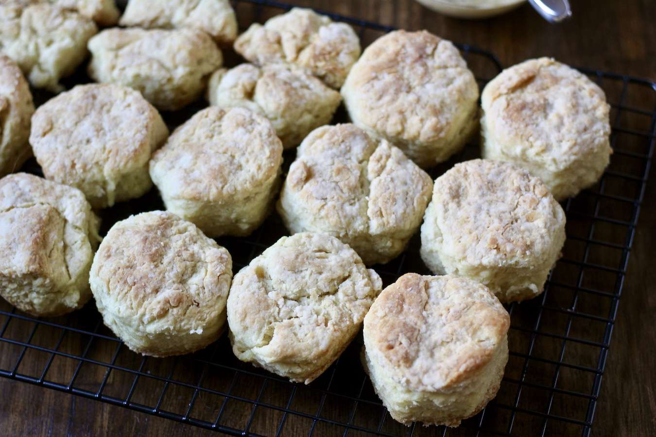 Skillet biscuits cooling on a cooling rack on a wooden counter.