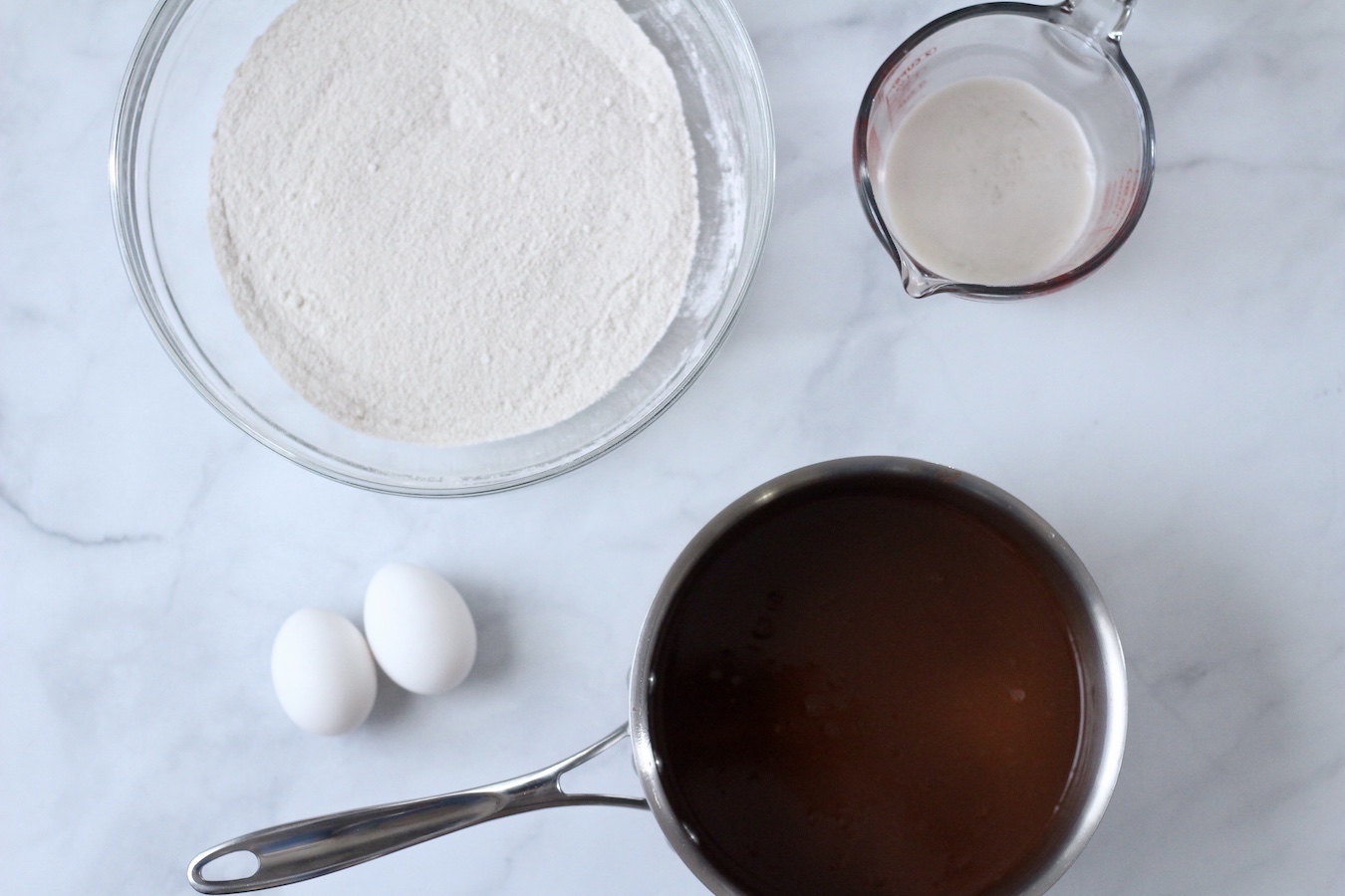 Ingredients to make Texas Sheet Cake on a marble counter.