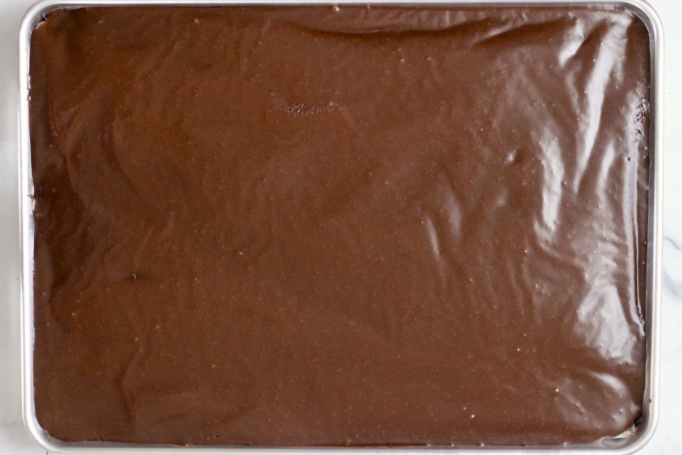 Frosting melted on the chocolate sheet cake.