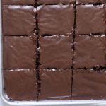 A sheet pan filled with glazed sheet cake.