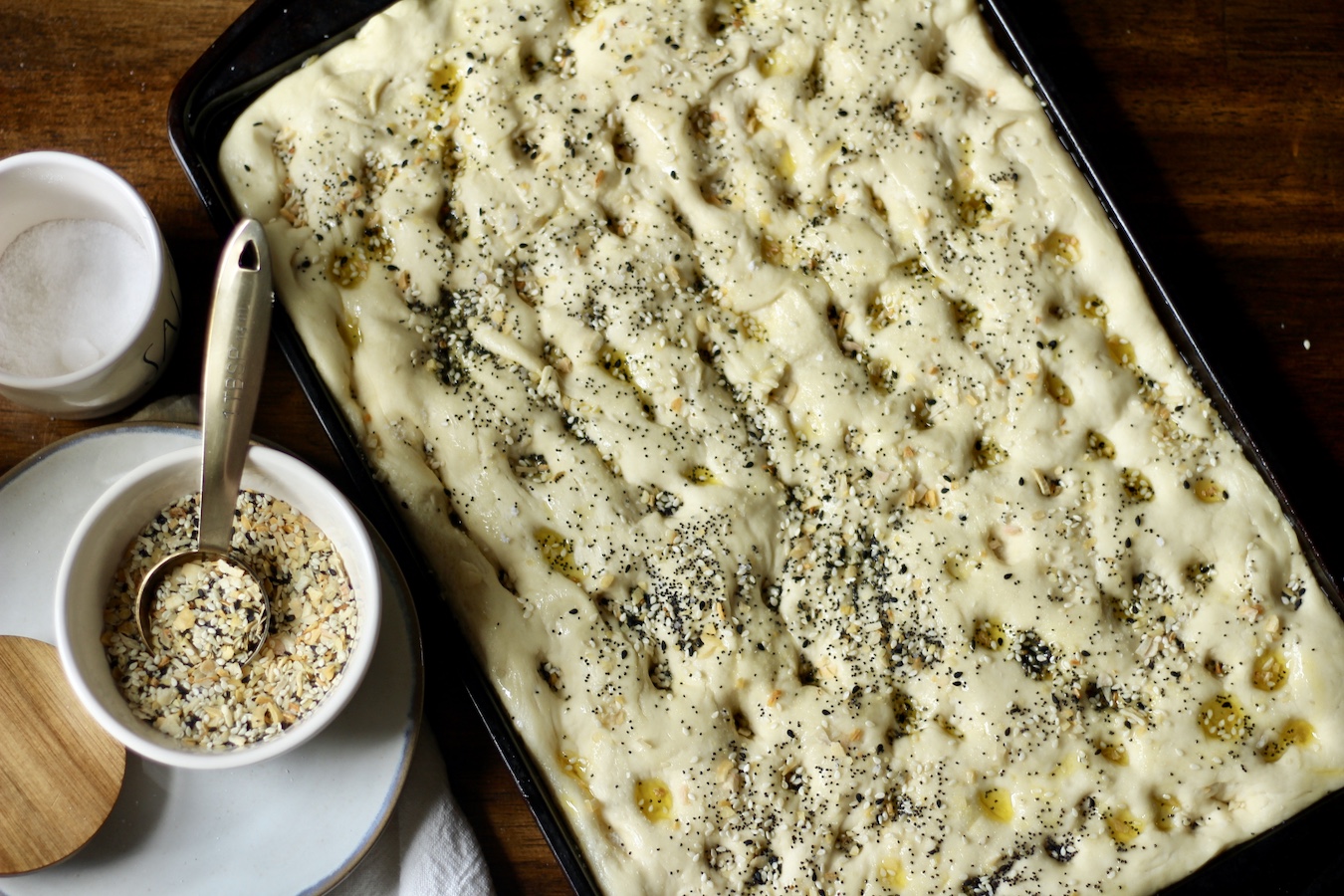 Breakfast focaccia before baking with everything but the bagel seasoning on top.