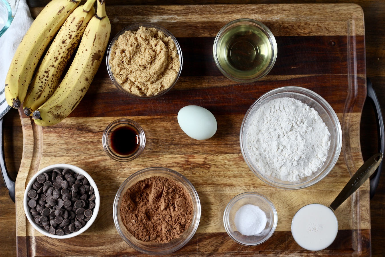 Ingredients for chocolate banana bread on a cutting board.