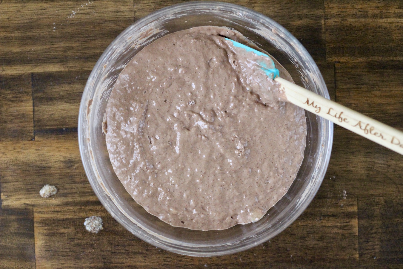 A large bowl of protein pancake batter on a wooden table.