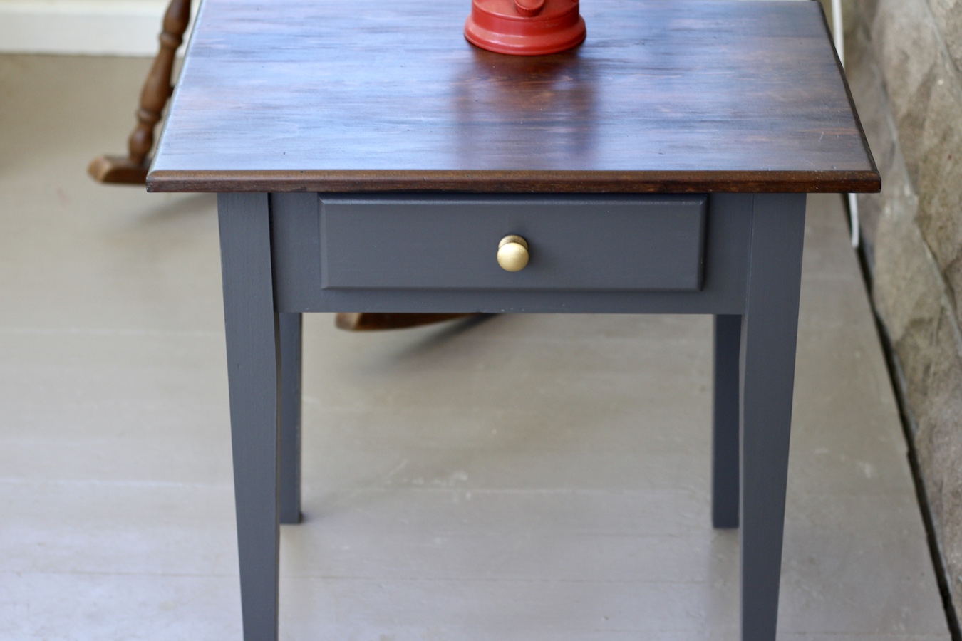 Nightstand with a small lantern on top.