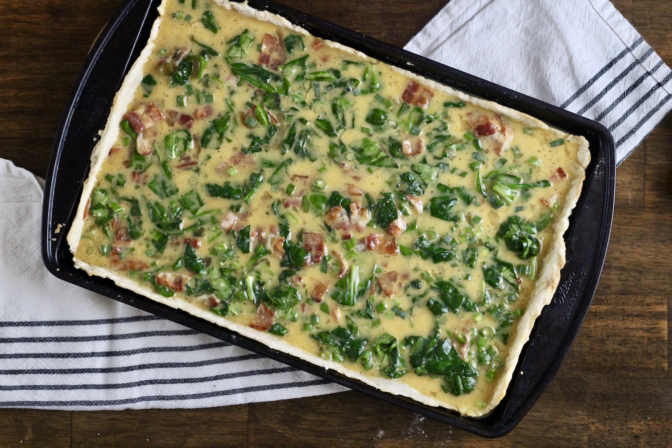 Uncooked slab quiche.