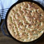 Oven baked skillet focaccia in a cast iron skillet.