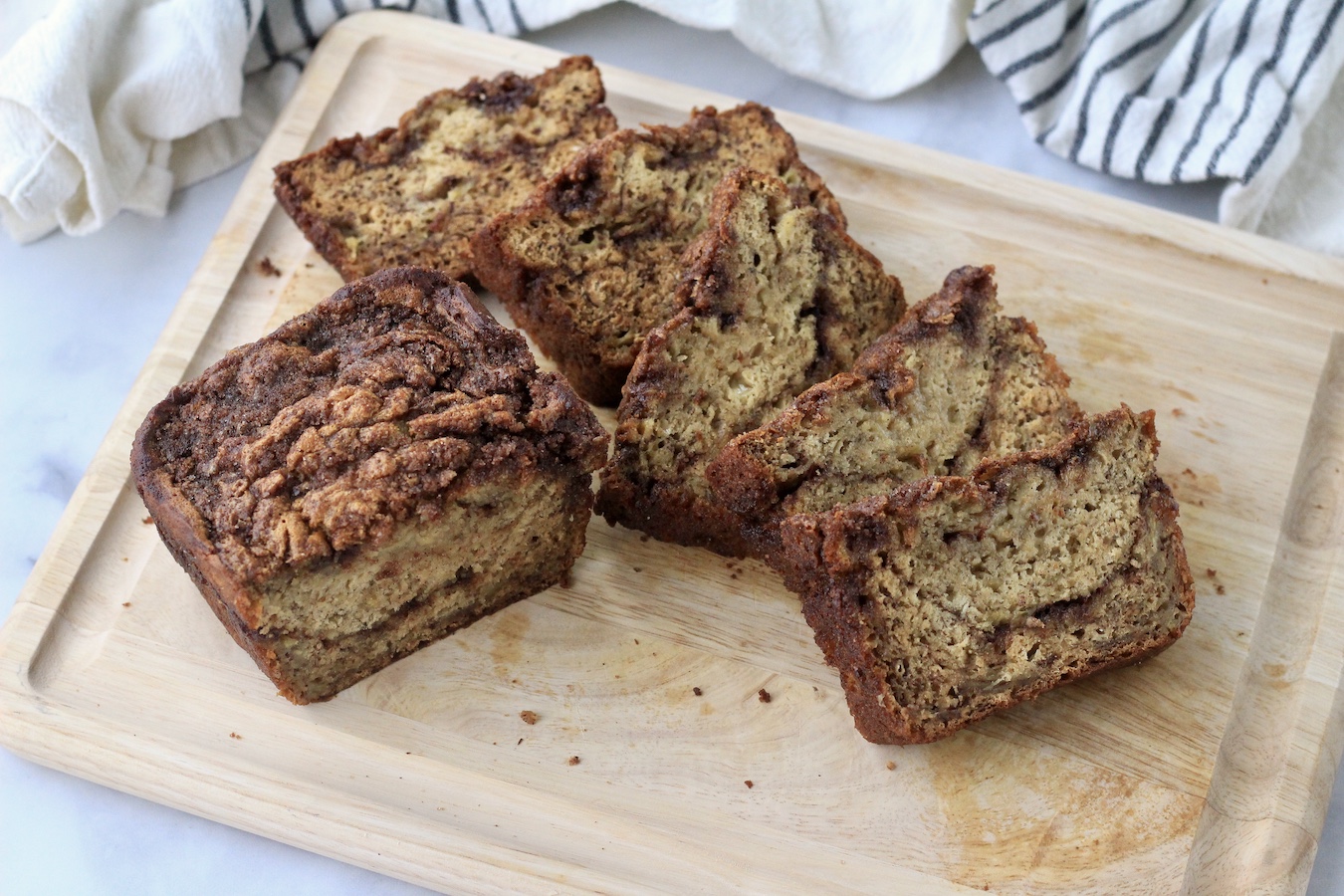 Sliced banana bread on a wooden counter.