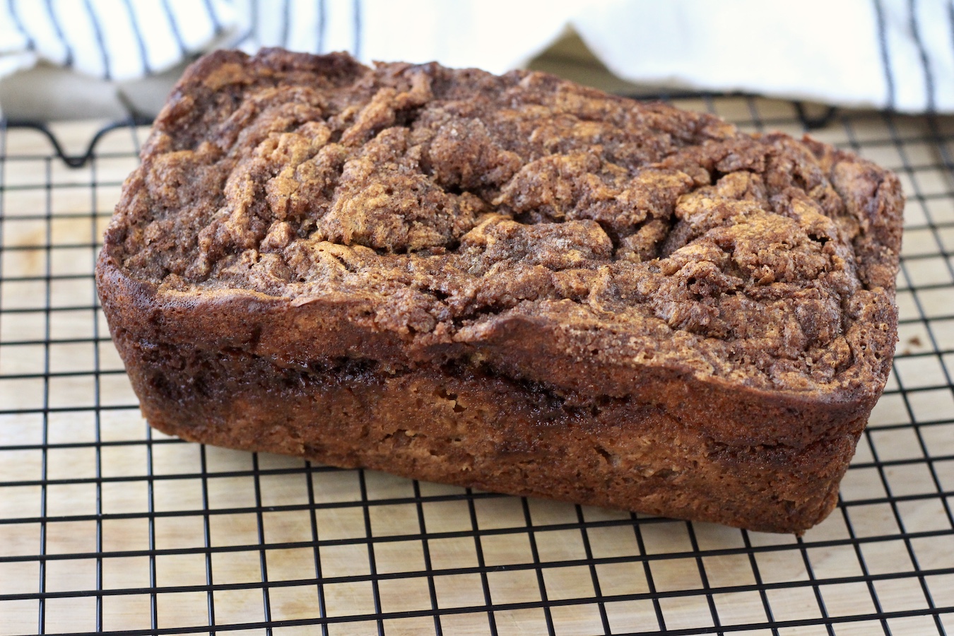 Baked cinnamon swirl banana bread on a cooling rack.