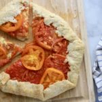 A cutting board with two slices of galette cut out.