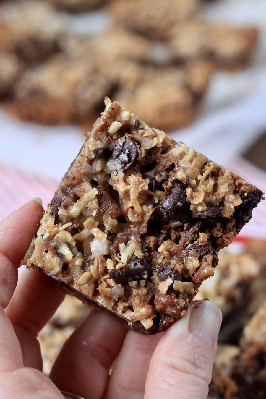 A hand holding a square magic cookie bar.
