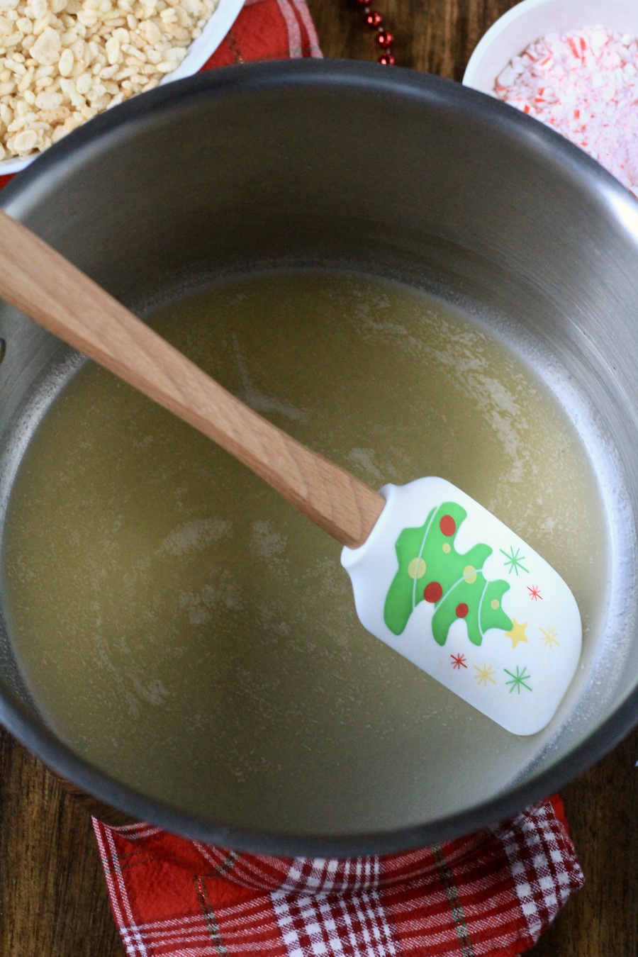 Melted plant based butter in a pot with a rubber spatula.