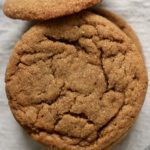A stack of soft ginger cookies on a white towel.