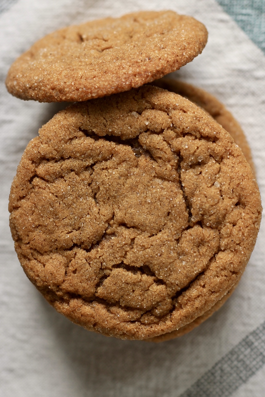 A stack of soft ginger cookies on a white towel.