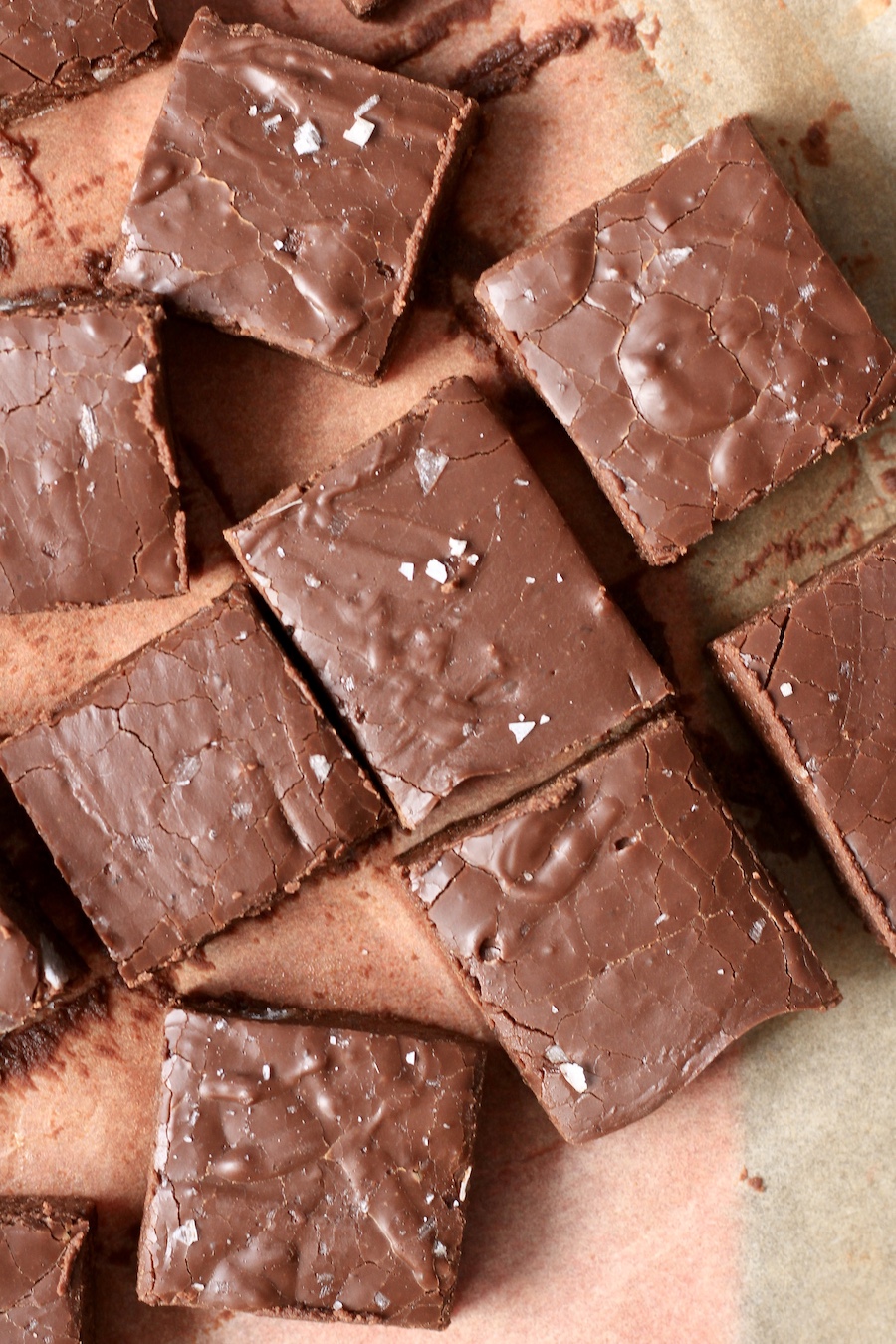 Pieces of easy chocolate fudge on parchment paper.