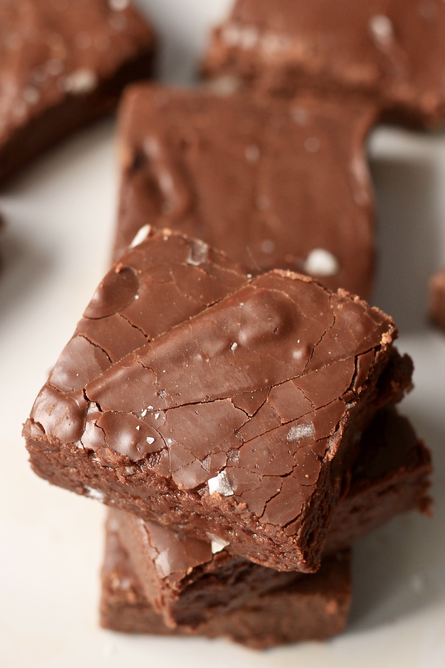 The side angle of a stack of chocolate fudge sprinkled with sea salt.