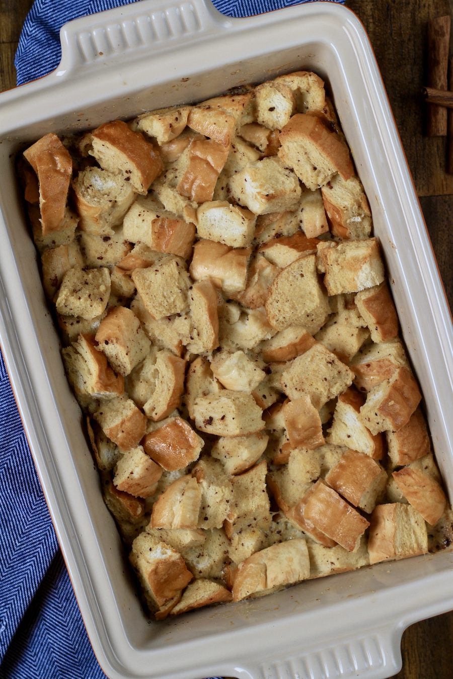 A baking dish with the soaked bread pudding before baking in the oven.