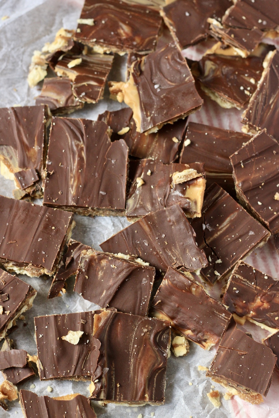 Chocolate peanut butter toffee on a parchment paper.