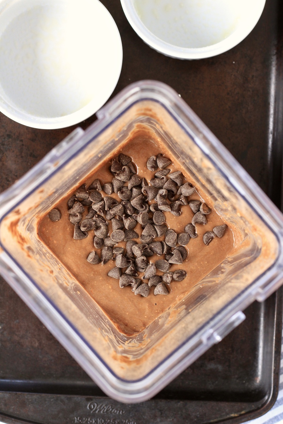 Chocolate chips on top of the blended chocolate oats.