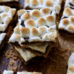 A stack of three s'mores toffee pieces with other pieces of s'mores toffee around it.