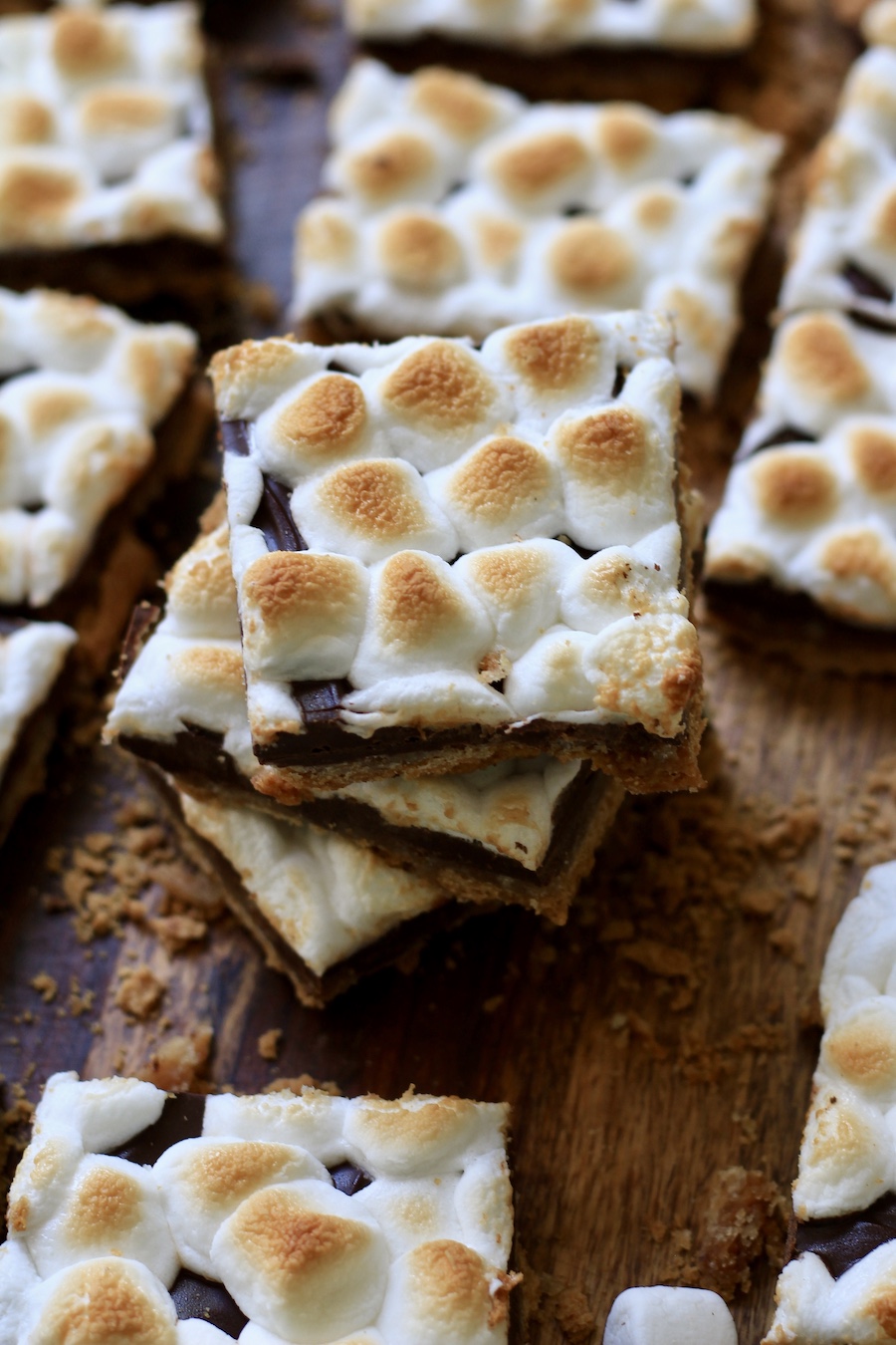 A stack of three s'mores toffee pieces with other pieces of s'mores toffee around it.