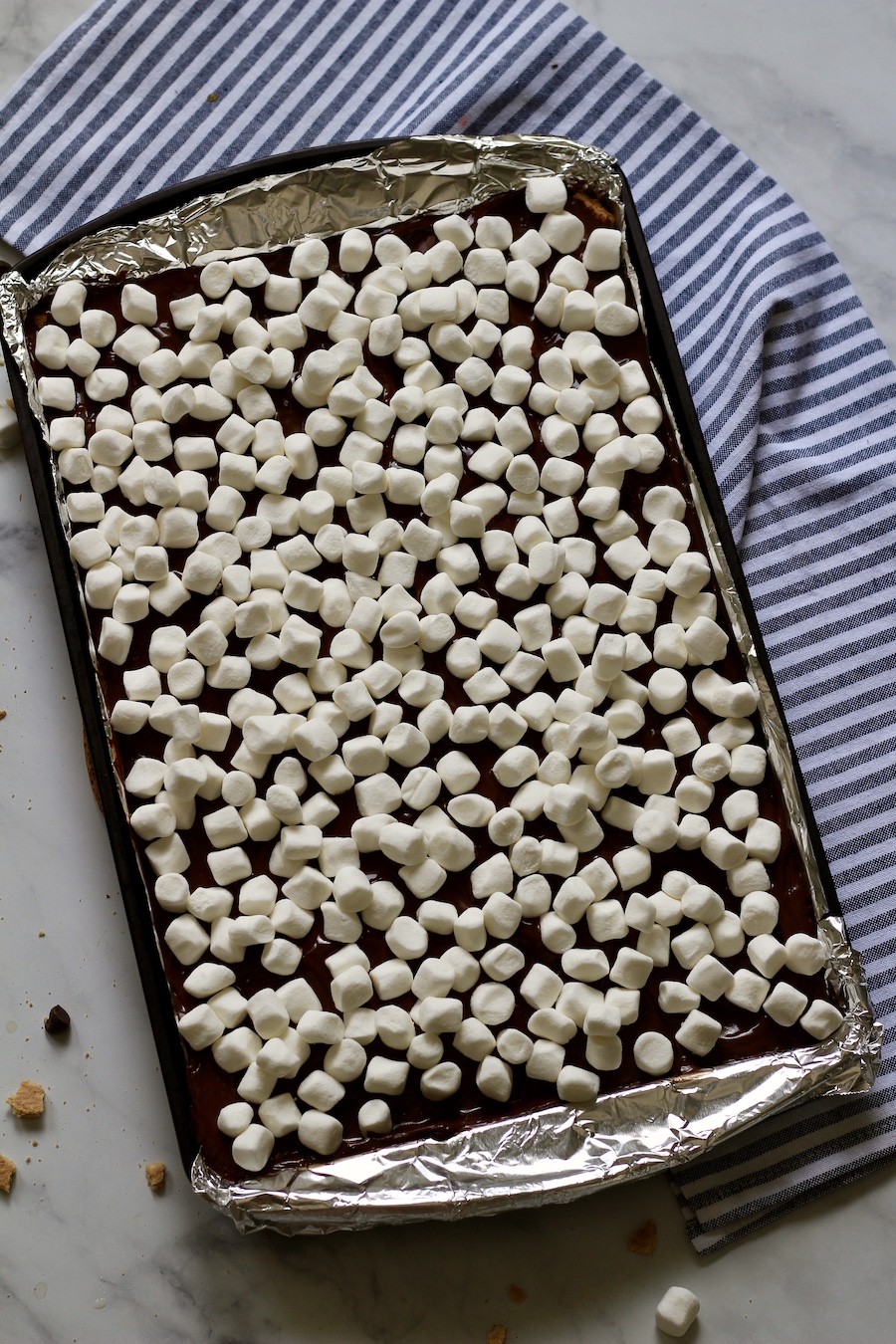 Unbaked marshmallows on top of chocolate toffee.