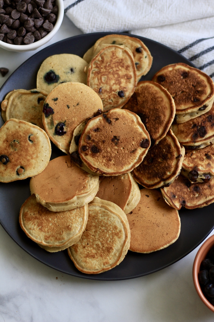 A close up of the mini buttermilk pancakes on a blue plate.