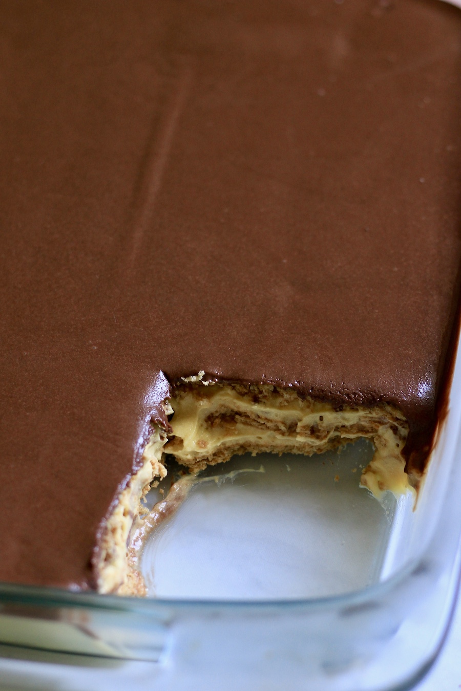 A close up shot of the chocolate eclair dessert pan after a square has been taken out.