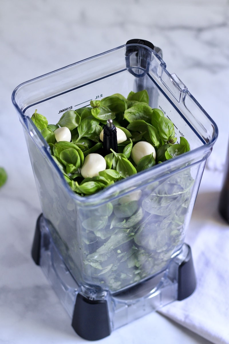 A top down photo of the spinach pesto ingredients in the belnder.
