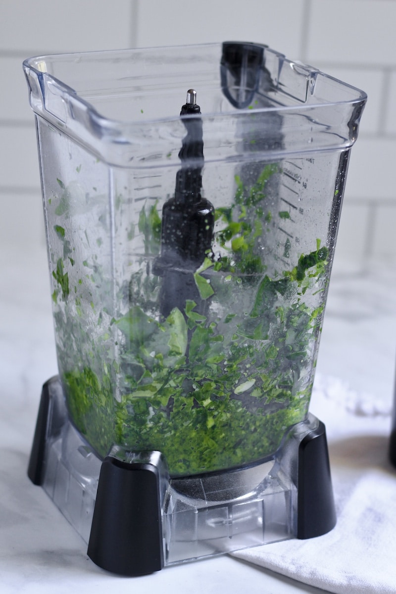 Spinach pesto ingredients after being pulsed in the blender.