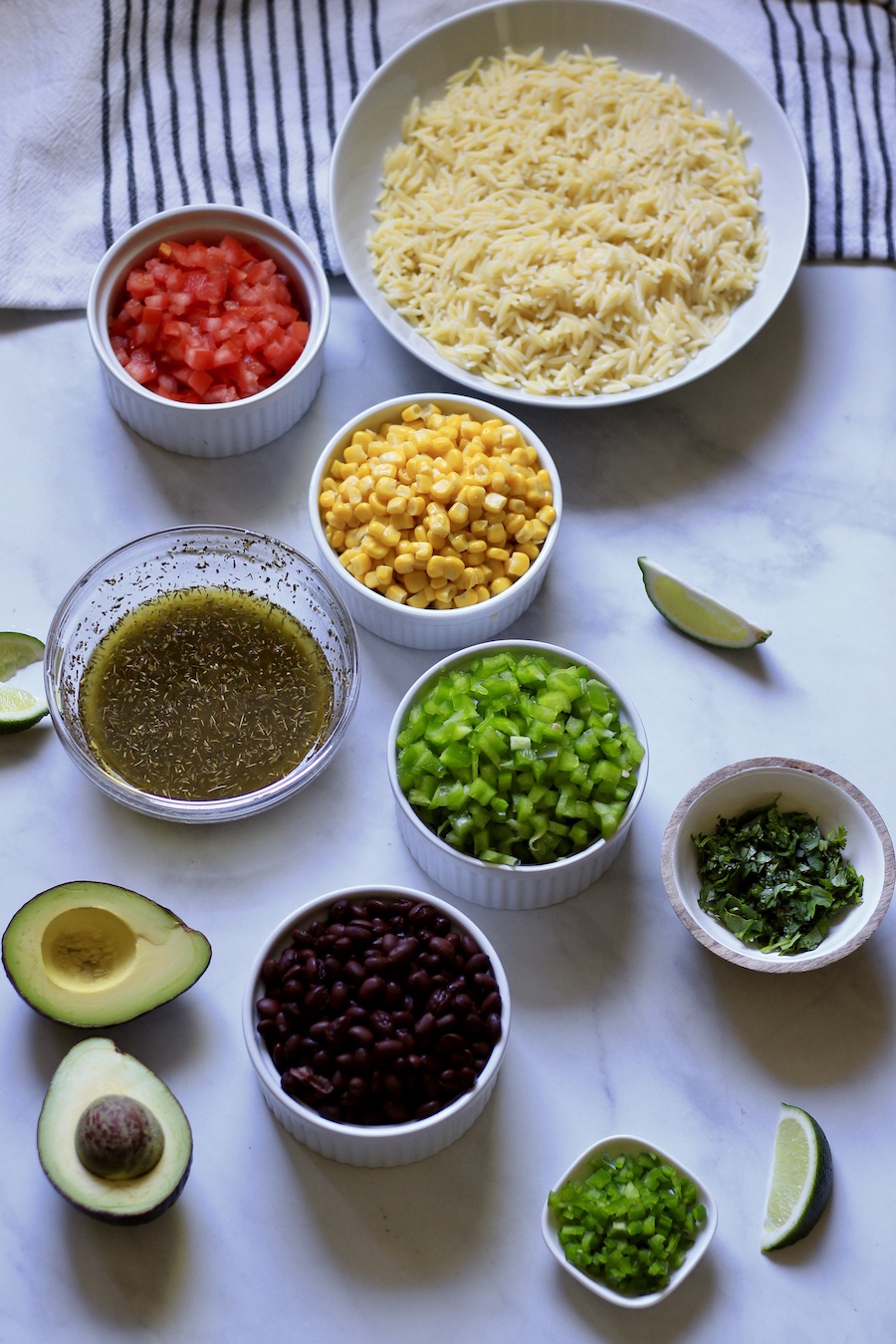 Bowls with ingredients for texas caviar pasta salad.