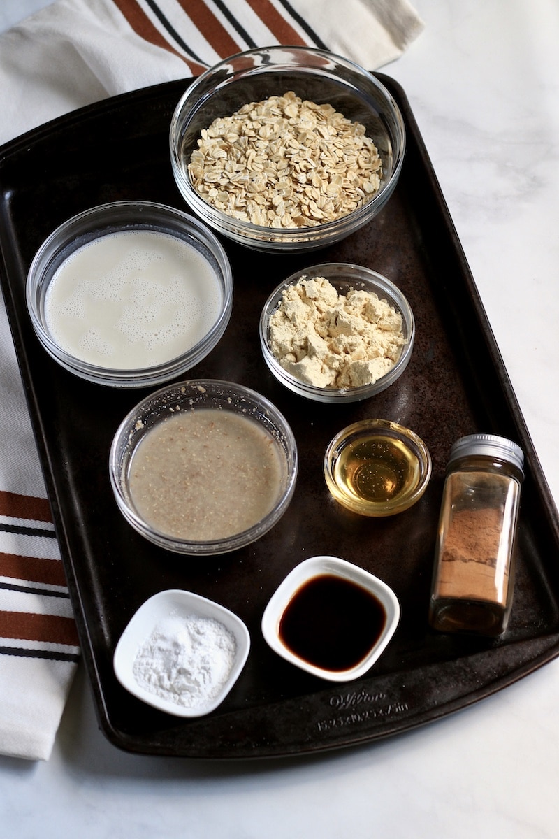 Top down photo of a baking sheet with the ingredients for snickerdoodle baked oats.
