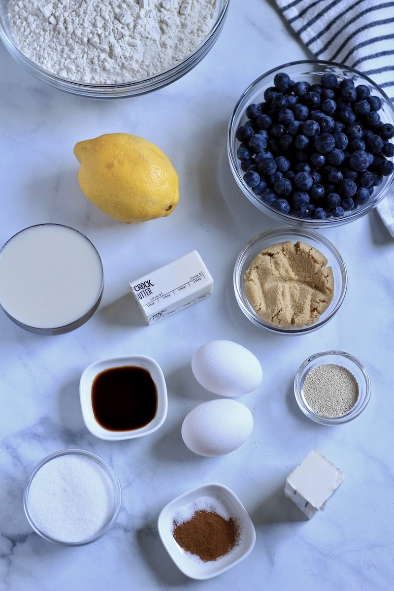 Ingredients for lemon blueberry sweet rolls on a white counter.