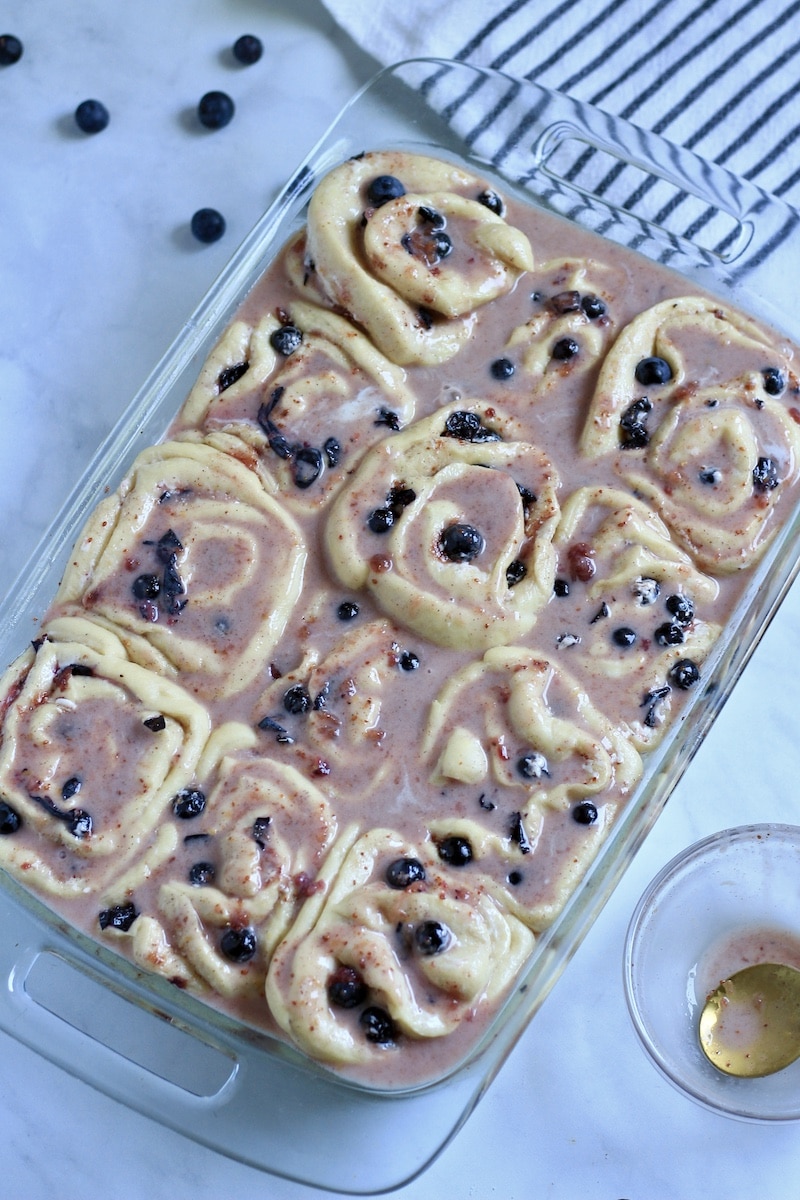 Reserved blueberry juices mixed with plant-butter poured over the sweet rolls while they rise.