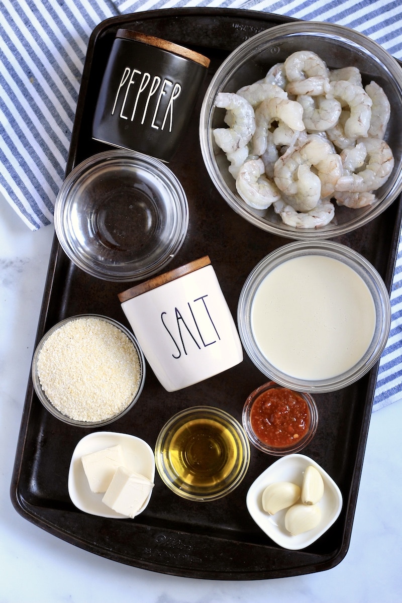 All ingredients for chili garlic shrimp and grits on a metal baking sheet.