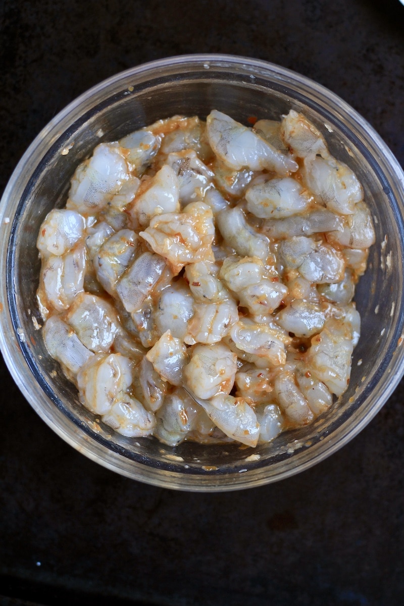A bowl with the chili garlic shrimp ingredients after stirring together.
