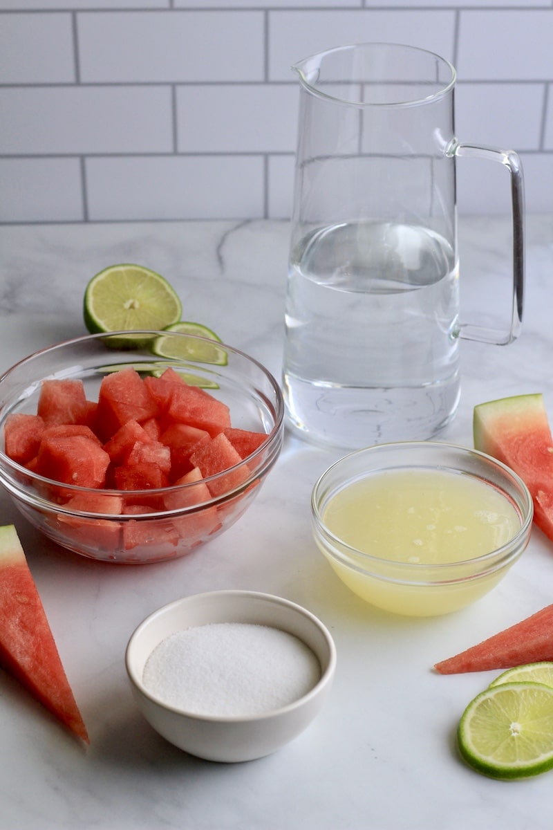 Ingredients for watermelon limeade on a white counter.