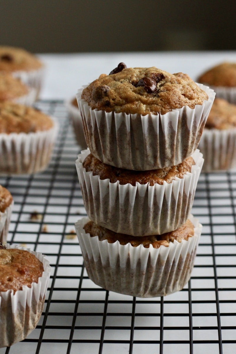 Three chunky monkey muffins in a small stack after baking.
