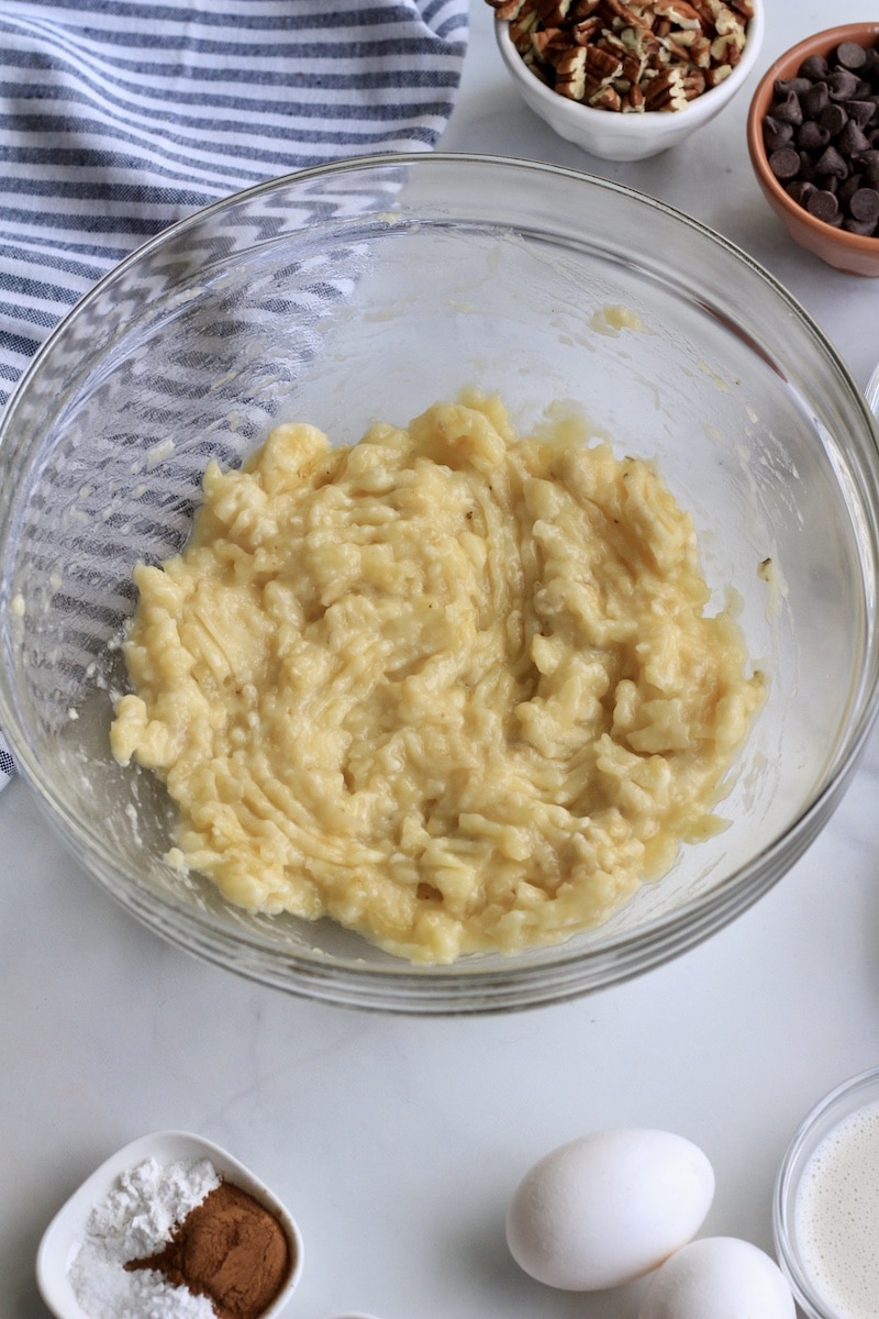 A large glass bowl with massed banana.