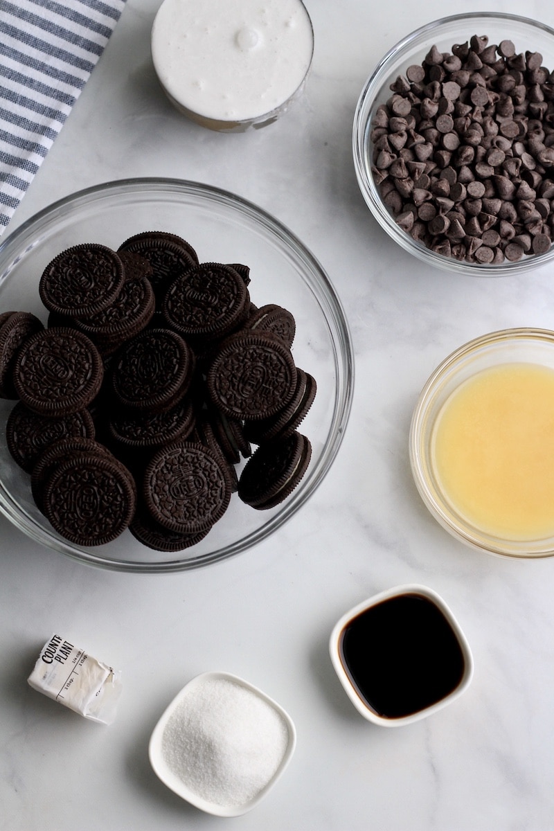 Ingredients for no bake mini chocolate tarts on a counter in bowls.