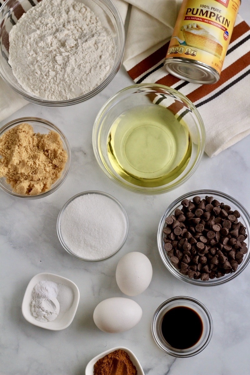 Ingredients for pumpkin chocolate chip muffins in individual bowls.