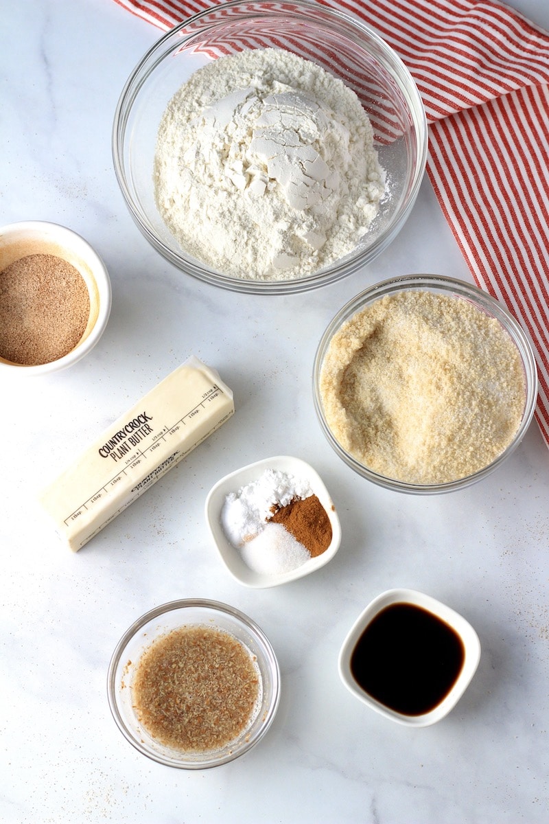 Ingredients for vegan snickerdoodle cookies on a counter with a white and red towel.