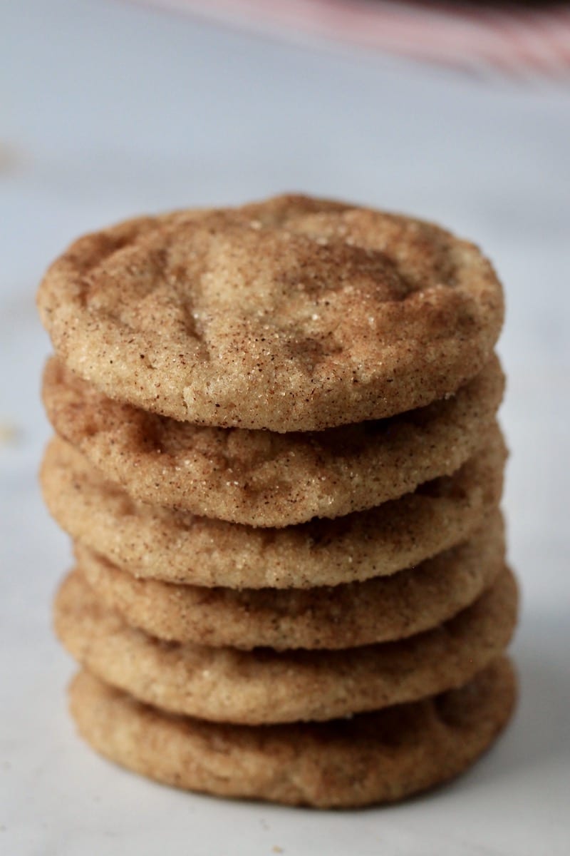 A stack of vegan snickerdoodle cookies from the side where you see the edges of the cookies.