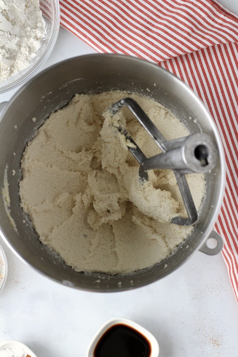A mixing bowl with the paddle attachment after creaming butter and sugar.