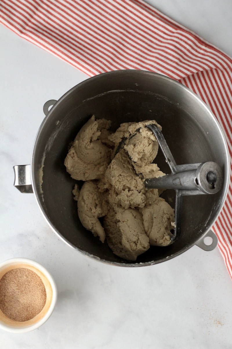 A mixing bowl with vegan snickerdoodle cookie dough.